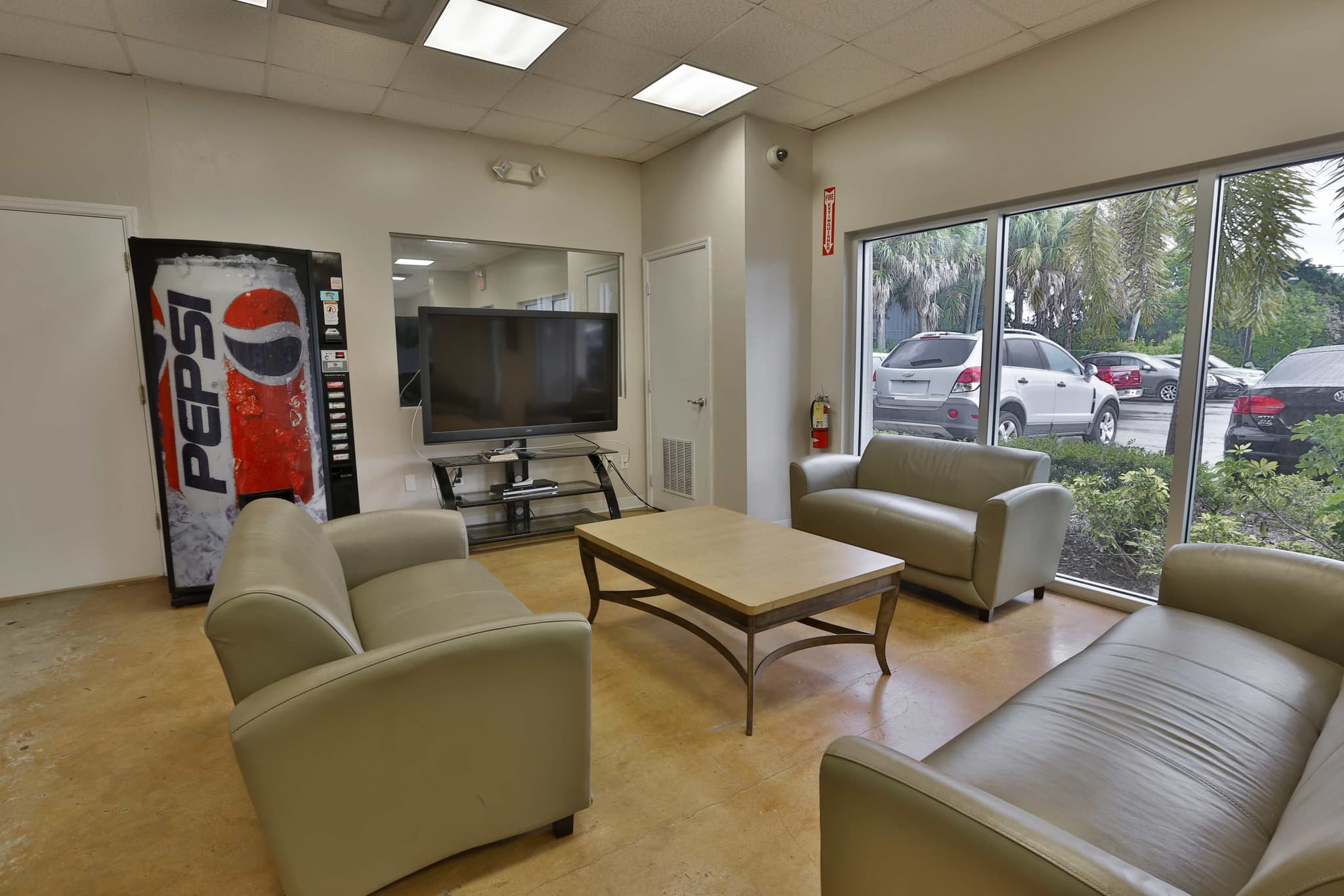 Customer waiting lounge at J&C Auto Sales, looking out over the lot